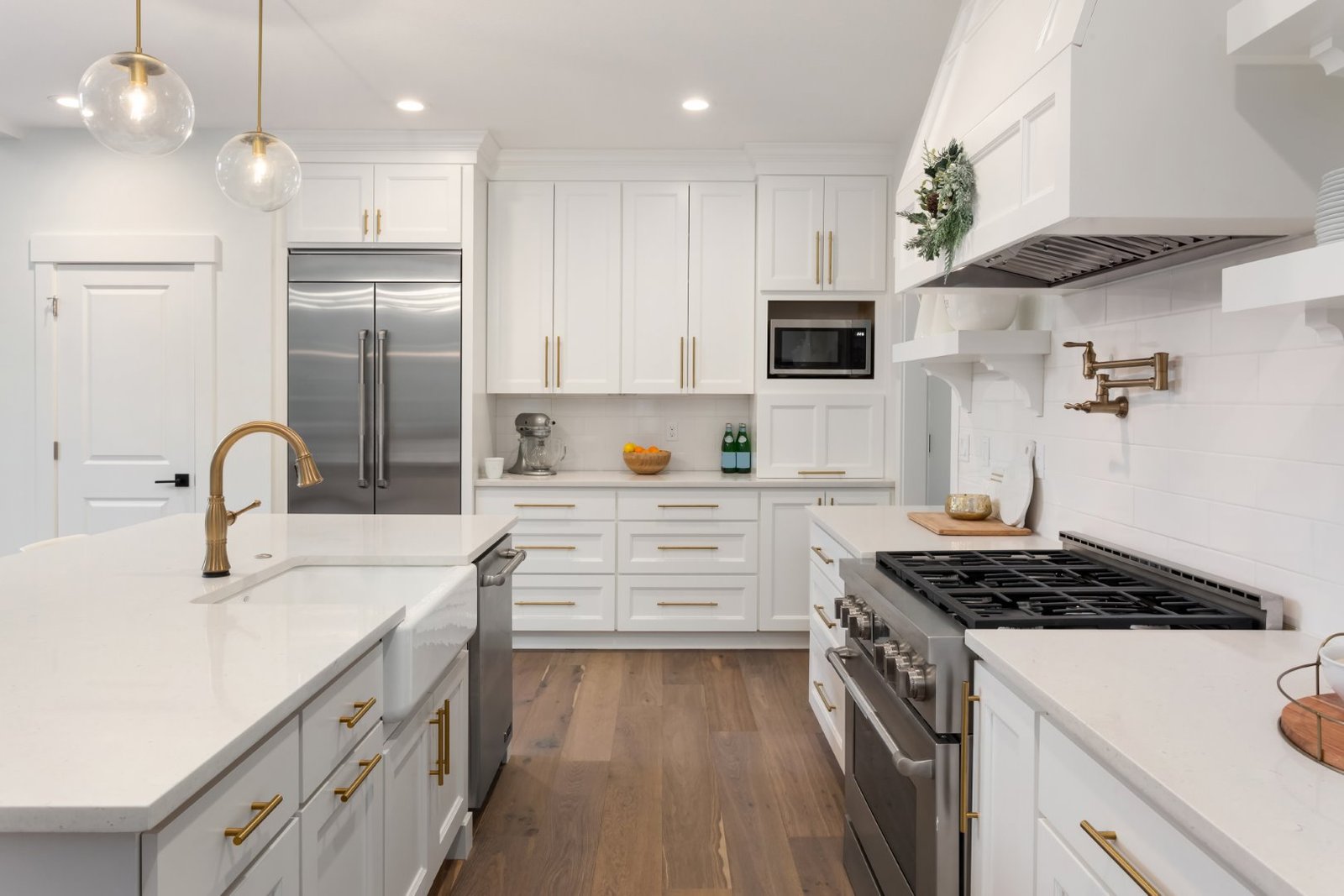 Bright white kitchen with brass fixtures