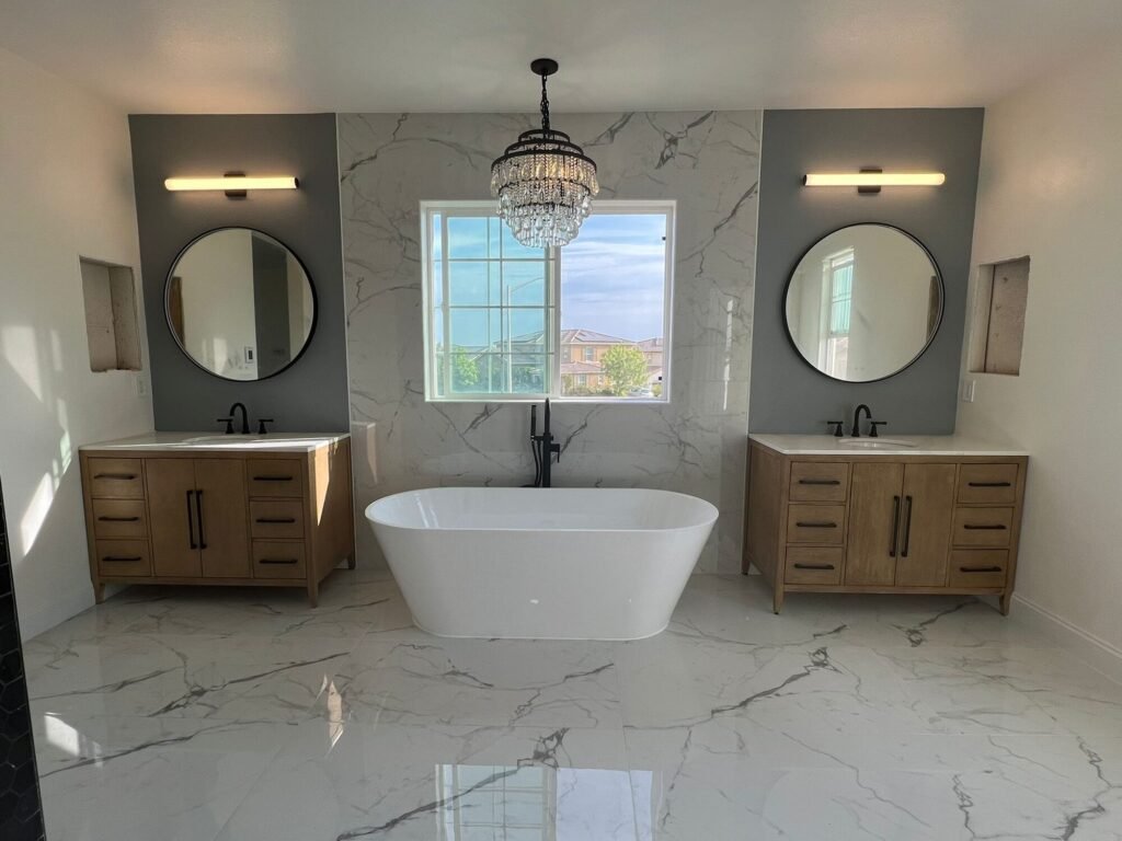 Master bathroom remodel with freestanding tub, marble floors and double vanities - Rafa Home Builders