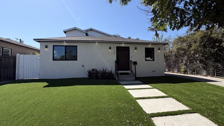 Front yard with artificial turf and a stepping-stone path