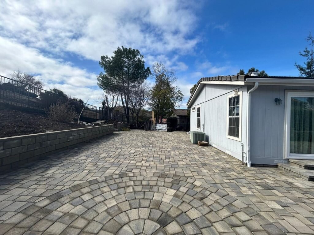 Interlocking paver driveway at a single-story home - Rafa Home Builders