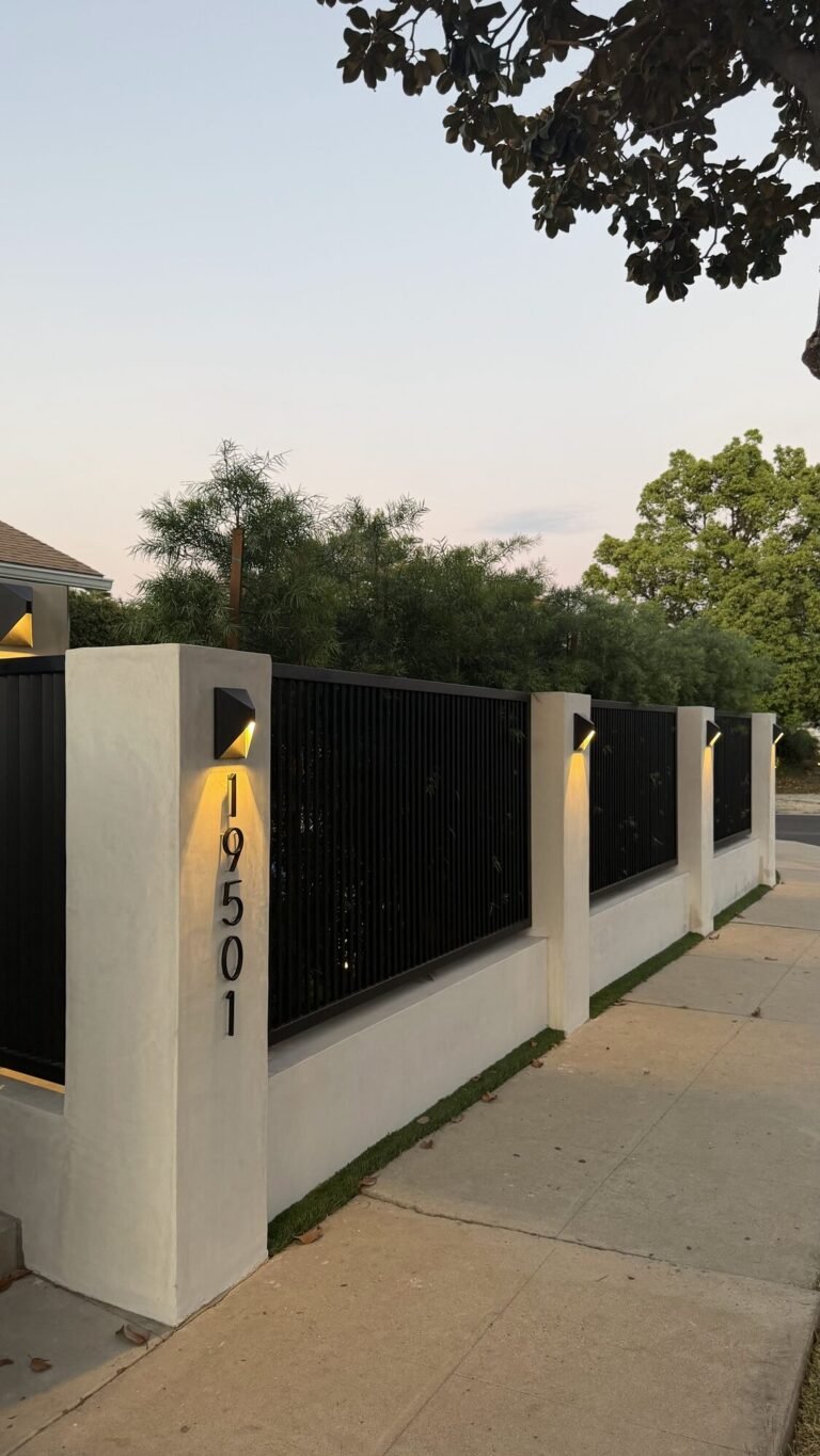 Stucco wall with metal fencing and wall lights
