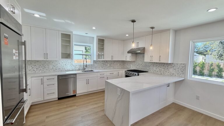 Quartz waterfall peninsula with stainless appliances