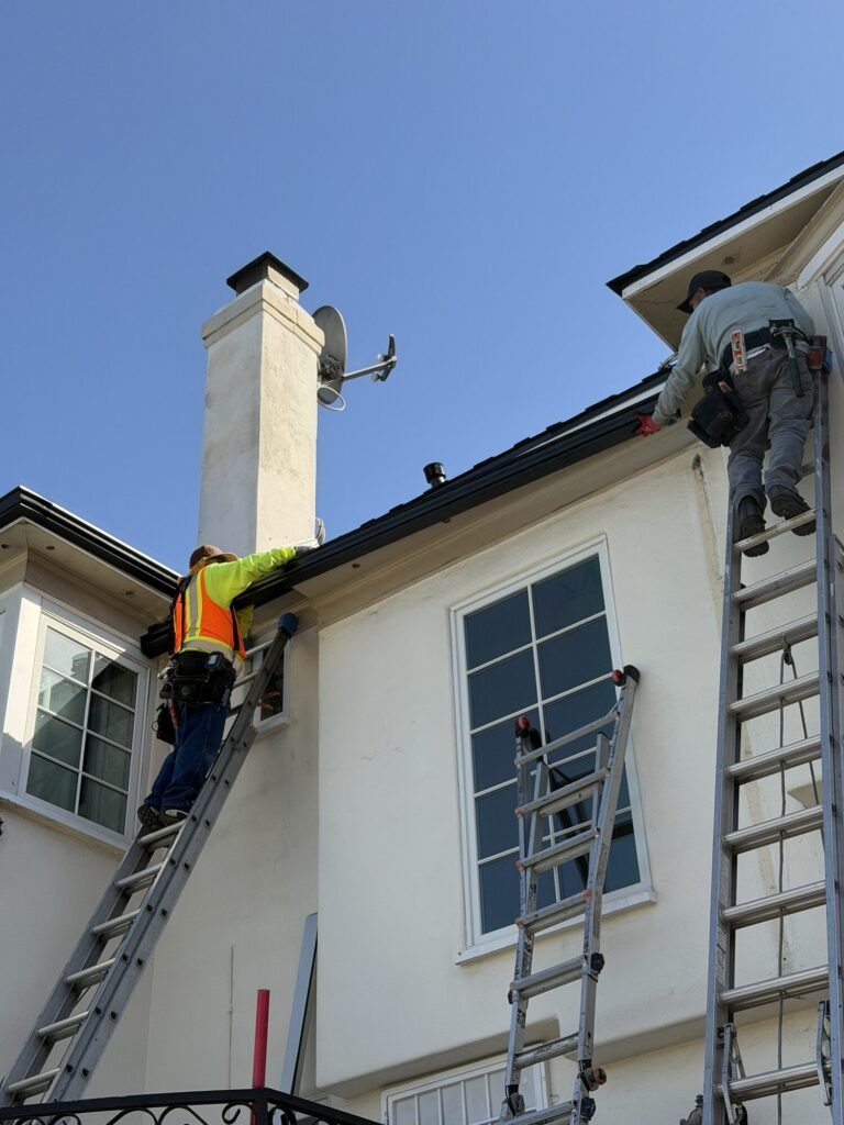 Crew working on a roof and chimney